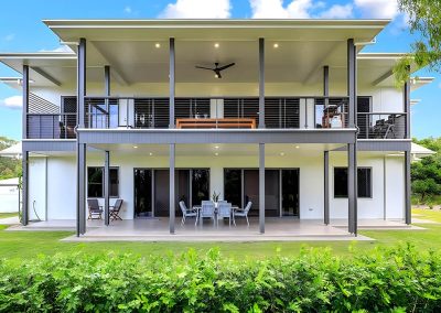 Rear of a two-storey home with wide covered decks on both levels