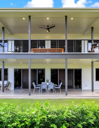 Rear of a two-storey home with wide covered decks on both levels