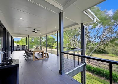 Covered deck with outdoor dining table, cable balustrade and bush views