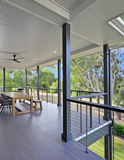 Covered deck with outdoor dining table, cable balustrade and bush views