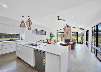 Kitchen island looking across to a living area with brick fireplace
