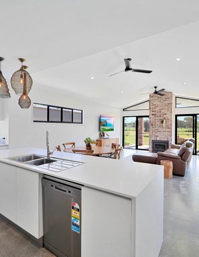 Kitchen island looking across to a living area with brick fireplace