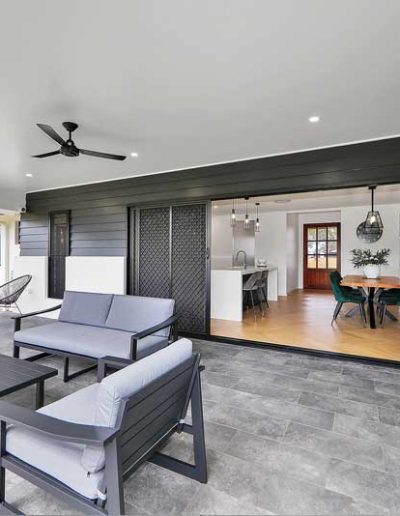 Covered alfresco with outdoor lounge set and sliding doors into the dining room