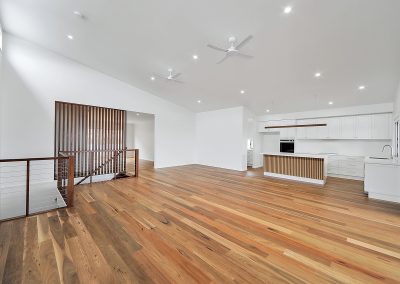 Timber-floored living area looking towards the kitchen