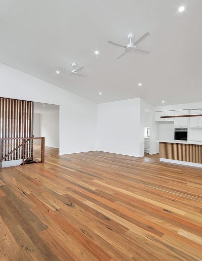 Timber-floored living area looking towards the kitchen