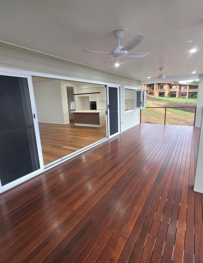Covered timber deck alongside glass sliding doors